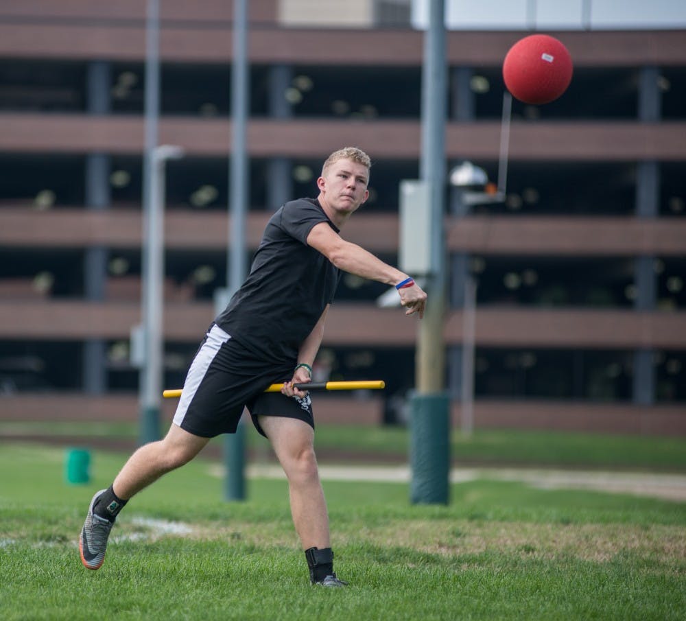 Psychology senior Roarke McAllister makes a long pass during the second Quidditch practice of the year on Sep. 2, 2018 at IM East.v