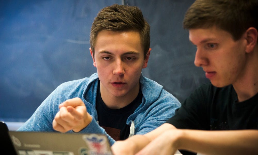 Social relations and policy sophomore Luc Walkington and Physics sophomore Evan Runburg prepare their statement during a debate against the University of Michigan on Feb.18, 2017 at Wells Hall. Michigan State hosted the district five qualifier to determine who goes to the 71st national debate tournament in March.