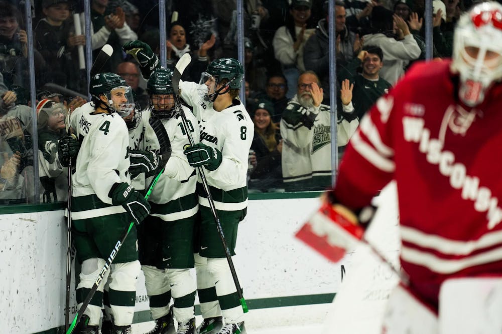<p>Tommi Männistö (10) celebrates an assist on a goal scored by Tanner Kelly (26) during Michigan State men's hockey game against the Wisconsin Badgers at Munn Ice Arena on Nov. 17, 2023.</p>