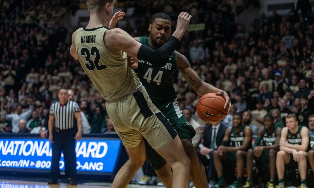 Junior forward Nick Ward (44) commits on offensive foul on Purdue's Matt Haarms at Mackey Arena on Jan. 27, 2019. The Spartans fell to the Boilermakers, 73-63.