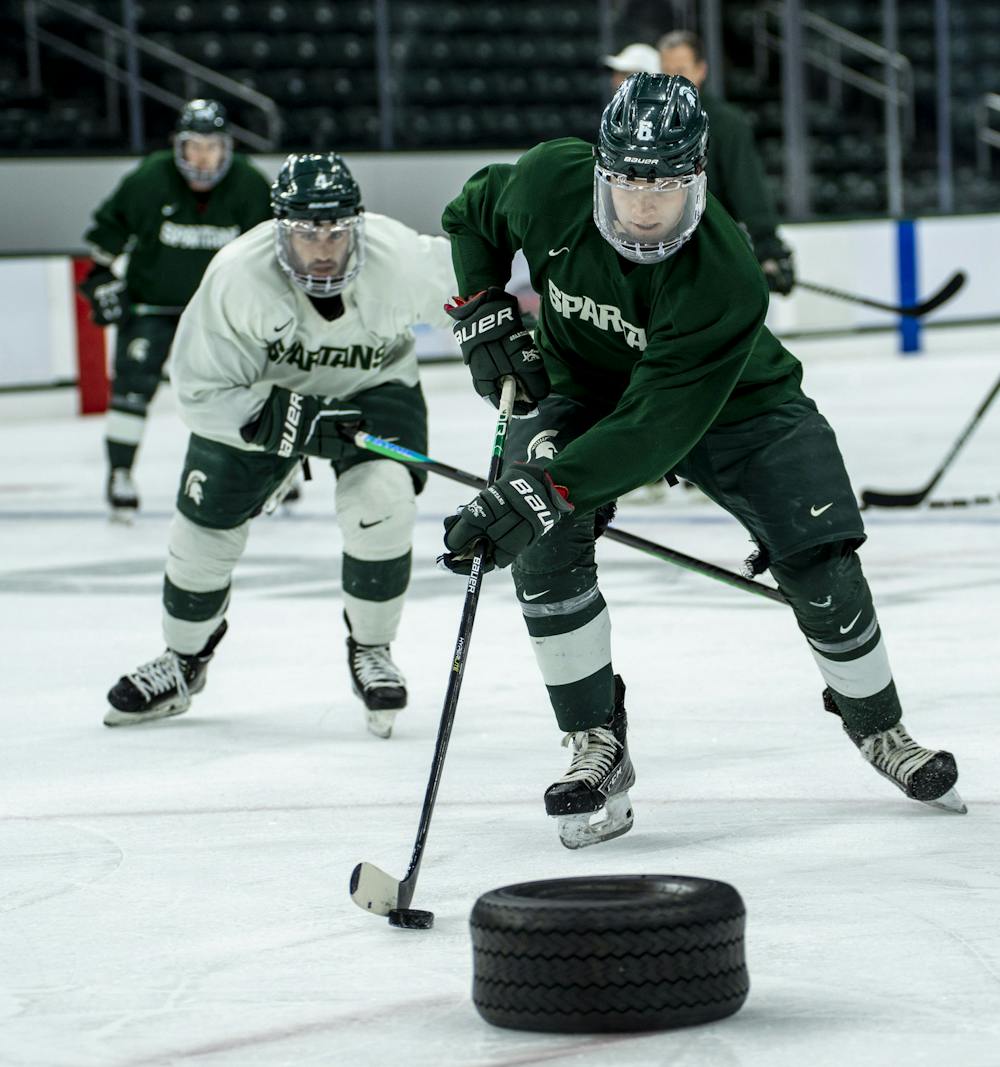 <p>Junior defense Cal Dybicz (6) moves with the puck as players of the Michigan State Spartans men&#x27;s ice hockey team run through drills during an open practice at Munn Ice Arena on Aug. 31, 2022. This practice marks the start of new Head Coach Adam Nightingale’s first full season at Michigan State. He was hired for the role in May 2022. </p>