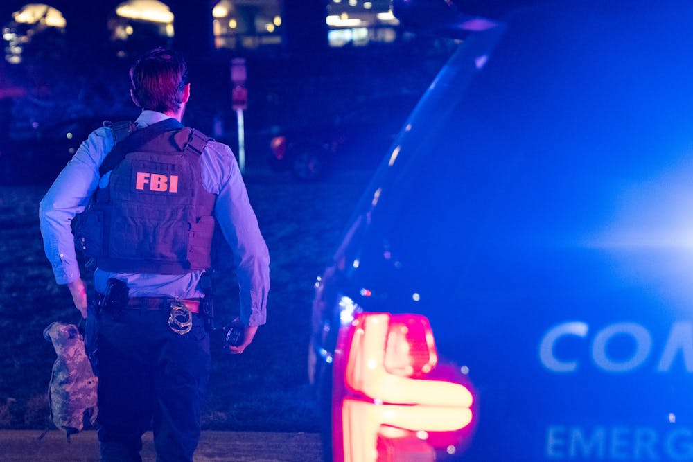 An FBI agent walks toward MSU Union during the response of a shooting on Michigan State’s campus on the night Feb. 13, 2023. 