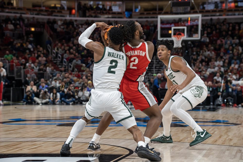 <p>Spartan Tyson Walker and Buckeye Bruce Thornton struggle for possession during their matchup at the United Center on March 10, 2023.</p>