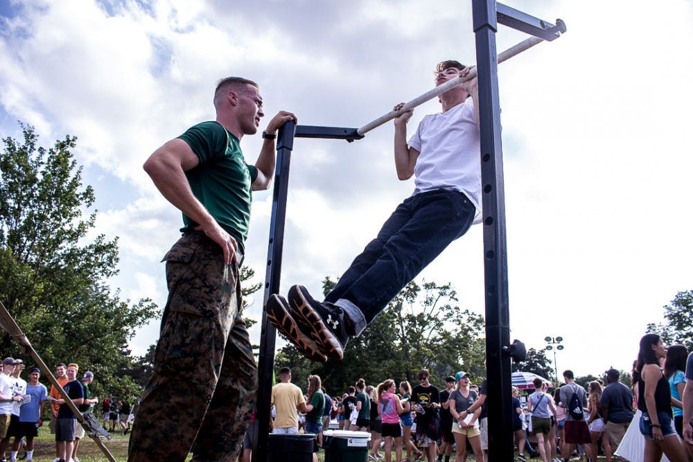 Mechanical engineering sophomore Lucas Russell does pull ups during Sparticipation on August 28, 2018 at Cherry Lane Field. Thousands of students attended the annual event which gives student organizations the chance to recruit new members.