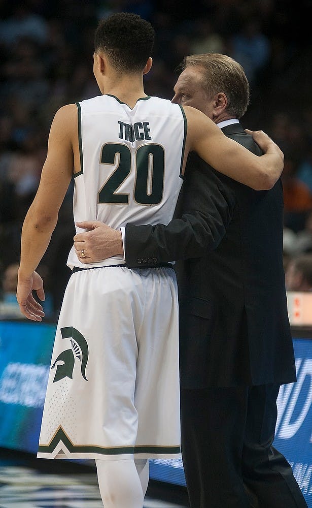 <p>Head coach Tom Izzo and senior guard Travis Trice embrace while watching the final play Mar. 20, 2015,  during the second round of the NCAA tournament in a game against Georgia at the Time Warner Cable Arena in Charlotte, North Carolina. The Spartans defeated the Bulldogs, 70-63. Alice Kole /The State News</p>