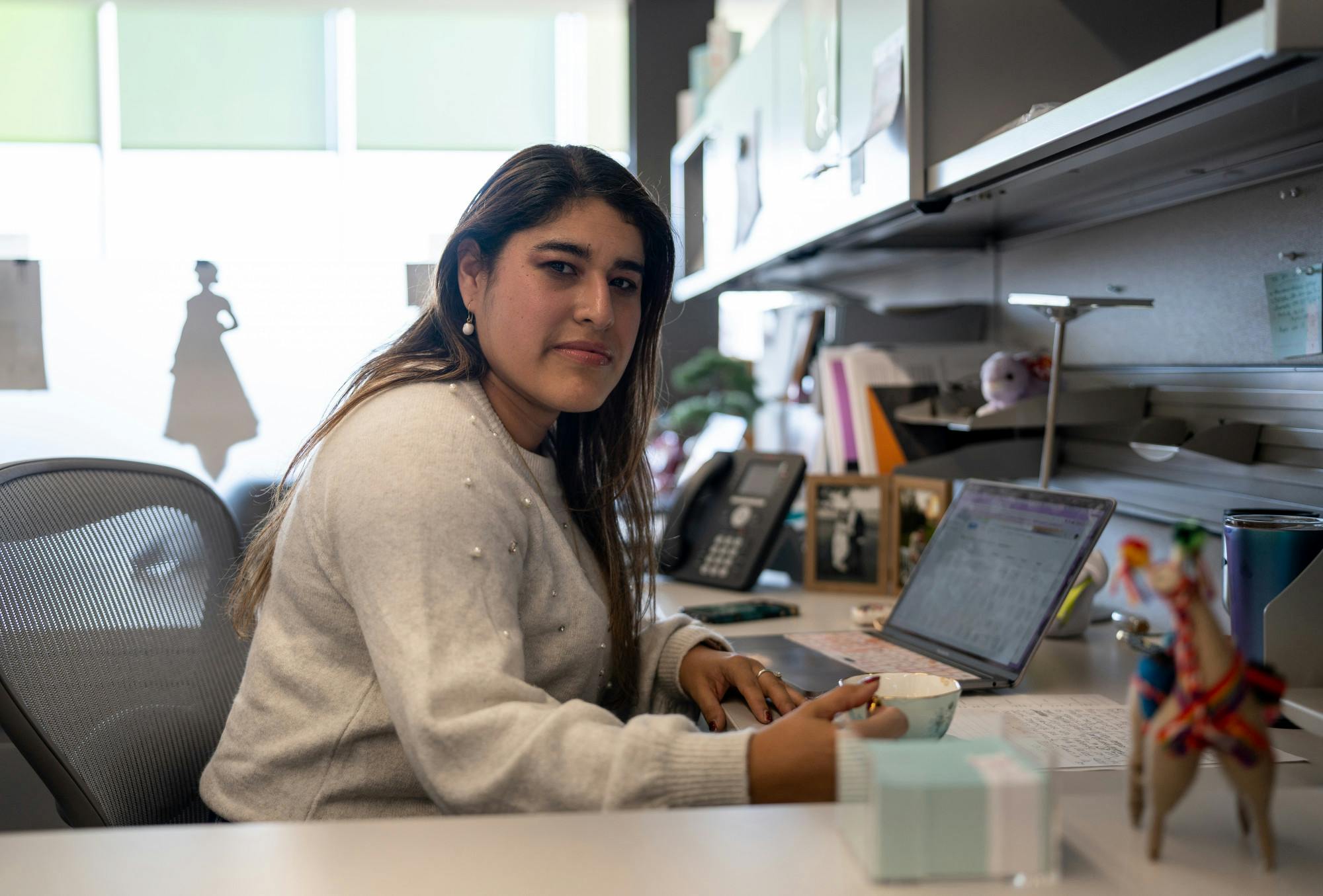 <p>Spanish professor Claudia Berrios-Campos poses for a photo in her office at Wells Hall on Nov. 9, 2022. </p>