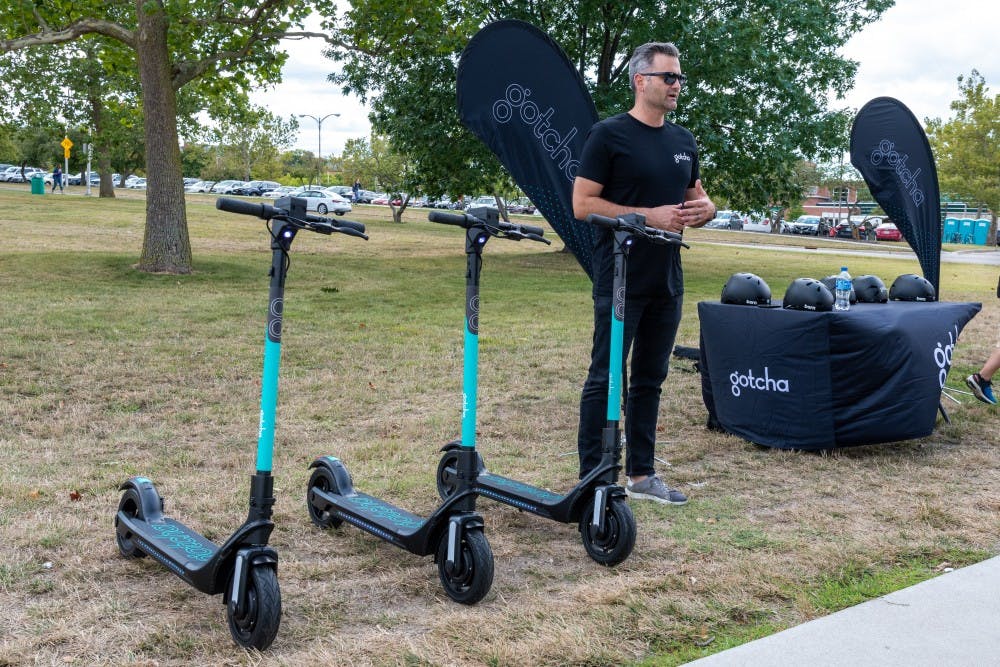 <p>Gotcha CEO and founder Sean Flood stands next to three Gotcha scooters on Aug. 28, 2019. </p>