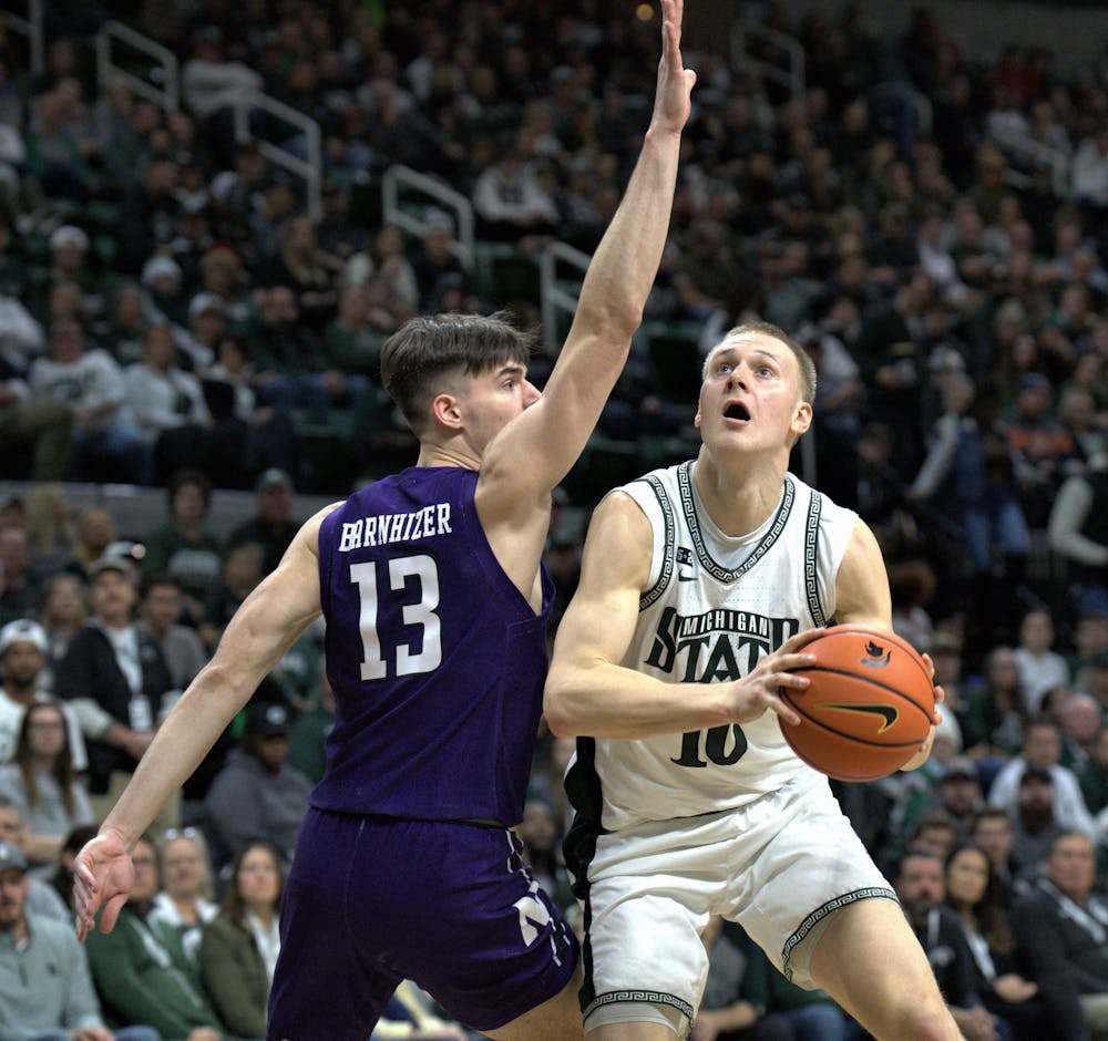 <p>Spartan forward Joey Hauser pushes against his Wildcat opponent on Dec. 4, 2022. ﻿</p>