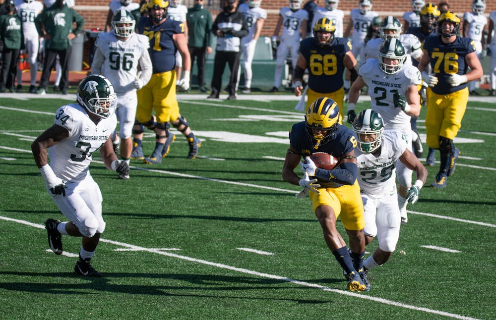 <p>Michigan&#x27;s wide reciever Cornelius Johnson (6) carries the ball in a rivalry game against MSU in Ann Arbor on Oct. 31, 2020.</p>