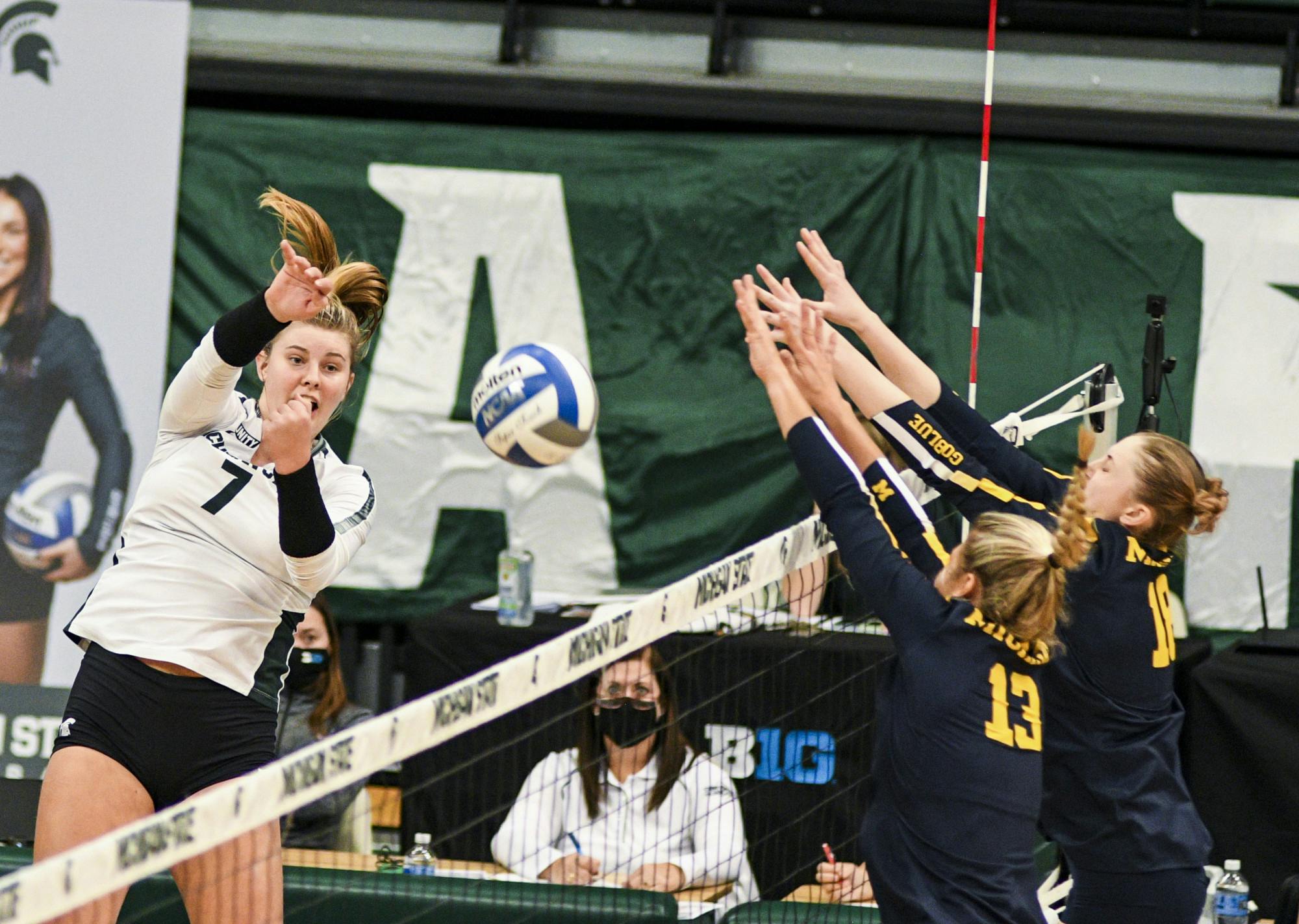 <p>Freshman outside hitter Sarah Franklin (7) attempts to hit the ball during the game against Michigan on Feb. 17, 2021 at the Jenison Fieldhouse. The Wolverines defeated the Spartans 3-1.</p>