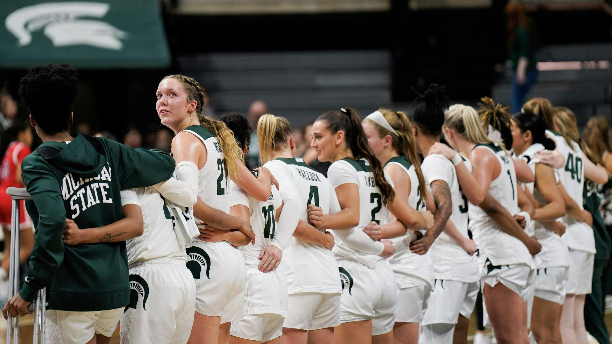 <p>Freshmen center Mary Meng (21) looks back as the women's basketball team sings Shadows after its win over Detroit Mercy on Nov. 16, 2023.</p>