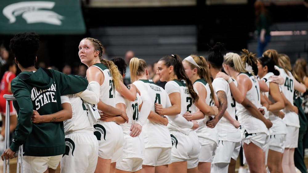 <p>Freshmen center Mary Meng (21) looks back as the women's basketball team sings Shadows after its win over Detroit Mercy on Nov. 16, 2023.</p>