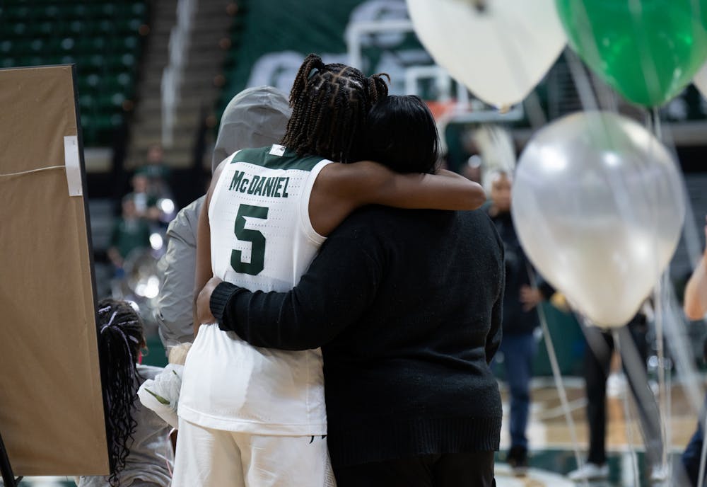<p>MSU guard Kamaria McDaniel hugs a family member while being honored at MSU's senior night celebration following the at-home victory at the Breslin Center in East Lansing on Wednesday, Feb. 22, 2023. McDaniel, along with fellow soon-to-be graduates Stephanie Visscher and Jayla James, took the floor one last time for a post-game ceremony.</p>