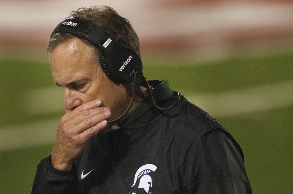 Head coach Mark Dantonio walks back to the sidelines after meeting with the team before going into overtime during the game against Indiana on Oct. 1, 2016 at Memorial Stadium in Bloomington, Ind. The Spartans were defeated by the Hoosiers in overtime, 24-21.