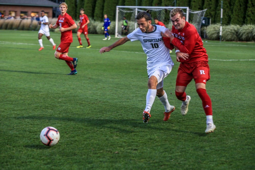 Junior midfielder Giuseppe Barone (10) runs with Rutgers’s forward Brian Hawkins (10) during the game against Rutgers on Sept. 21, 2018. The Spartans defeated the Scarlett Knights, 2-1.