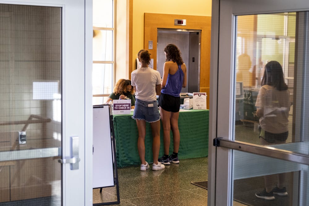 <p>Two people checked into their dorms at Shaw Hall on move-in day on Aug. 27, 2021.</p>