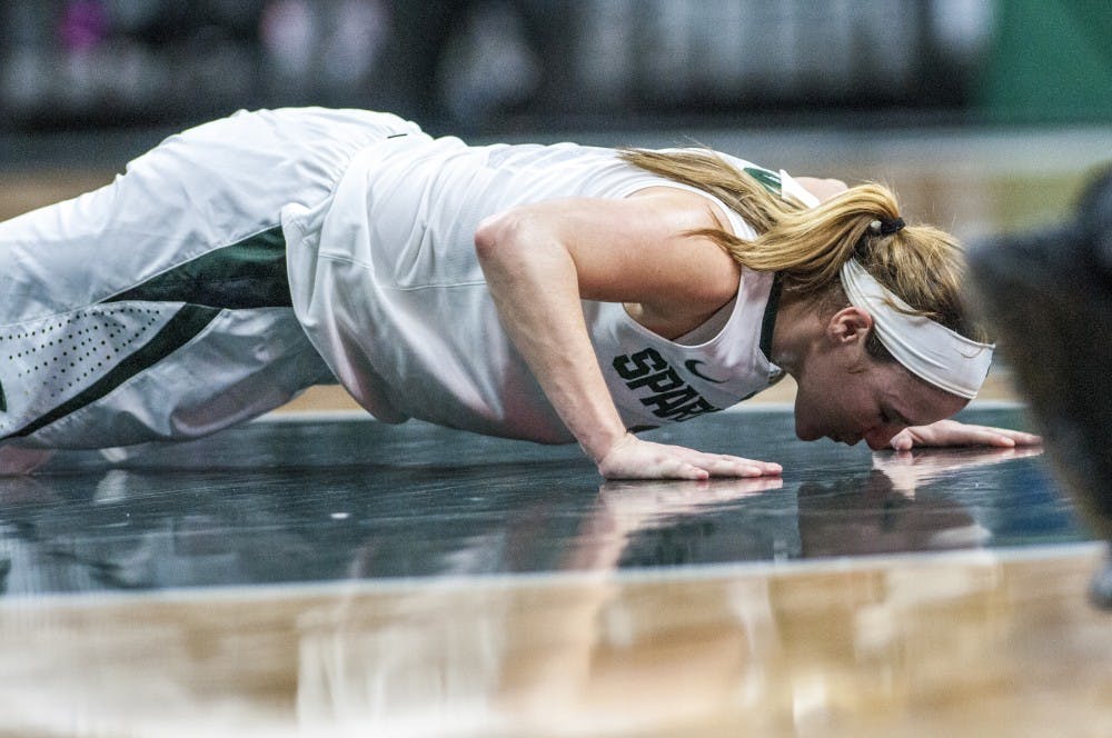 Senior guard Tori Jankoska (1) kisses the floor during the fourth quarter of the women's basketball game against Pennsylvania State University on Feb. 22, 2017 at Breslin Center. The Spartans defeated the Nittany Lions, 73-64.