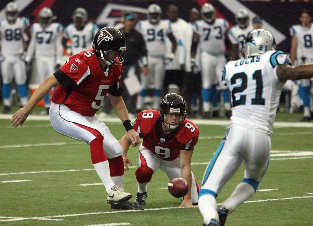 Atlanta Falcons punter Michael Koenen (9) fumbles the snap as Falcons kicker Morten Andersen (5) lines up for the attempted field goal, as Carolina Panthers cornerback Ken Lucas (21) charges in on the play in the first quarter. The Panthers defeated the Falcons, 27-20, at the Georgia Dome in Atlanta, Georgia, Sunday, September 23, 2007. (Curtis Compton/Atlanta Journal-Constitution/MCT)