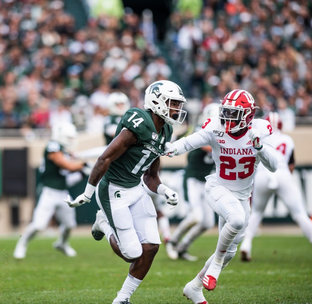 Redshirt freshman center back Davion Williams (14) rushes past Indiana’s defensive back Jaylin Williams (23) during the homecoming game against Indiana on Sept. 28, 2019 at Spartan Stadium. The Spartans led the Hoosiers 21-14 at halftime.