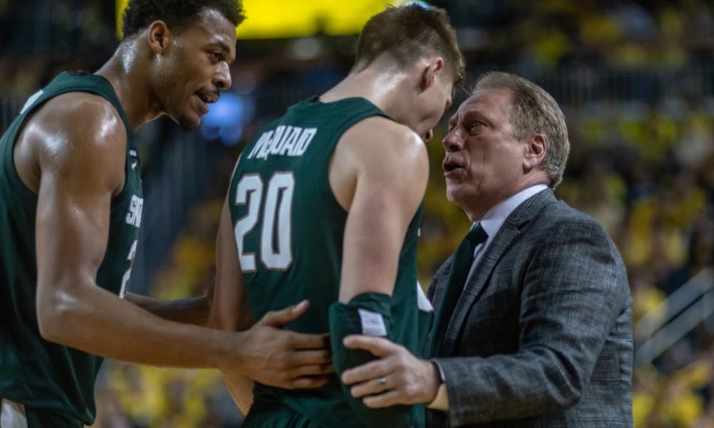 <p>Coach Tom Izzo talks to Senior guard Matt McQuaid (20) during a timeout. The Spartans beat the Wolverines, 77-70, Feb. 24, 2019 at the Crisler Center.</p>