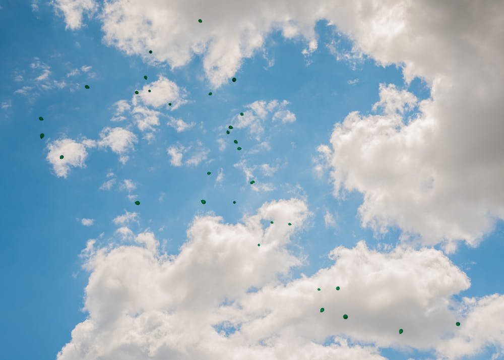 Balloons released at the memorial for long jumper Tony Martin float away from the Rock on Farm Lane July 20, 2020. Martin died in a shooting in his hometown of Saginaw the morning of July 19. Martin held the high school state record for the long jump, with a jump of 26 feet and six inches.