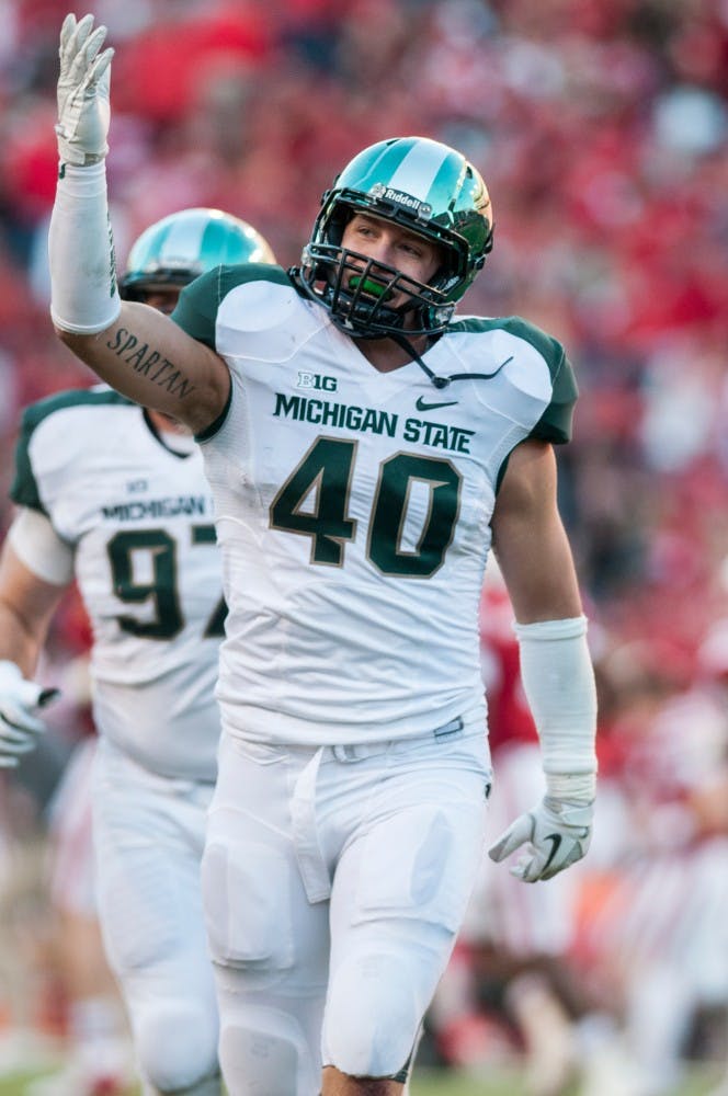 	<p>Senior linebacker Max Bullough pumps up the <span class="caps">MSU</span> fans as he heads to the locker room at halftime during the game against Nebraska on Nov. 16, 2013, at Memorial Stadium in Lincoln, Neb. The Spartans defeated the Cornhuskers, 41-28. Khoa Nguyen/The State News</p>