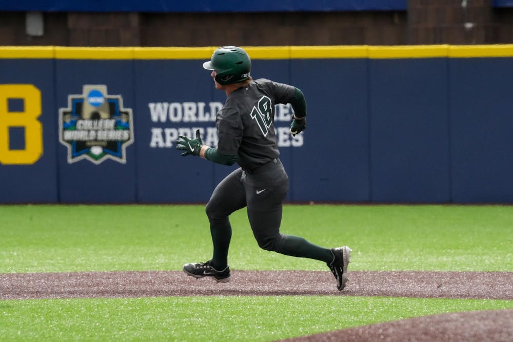 Michigan State senior catcher Noah Bright runs around first base while going to second on April 26, 2025. The Spartans lost to the Wolverines in the second game 9-2.