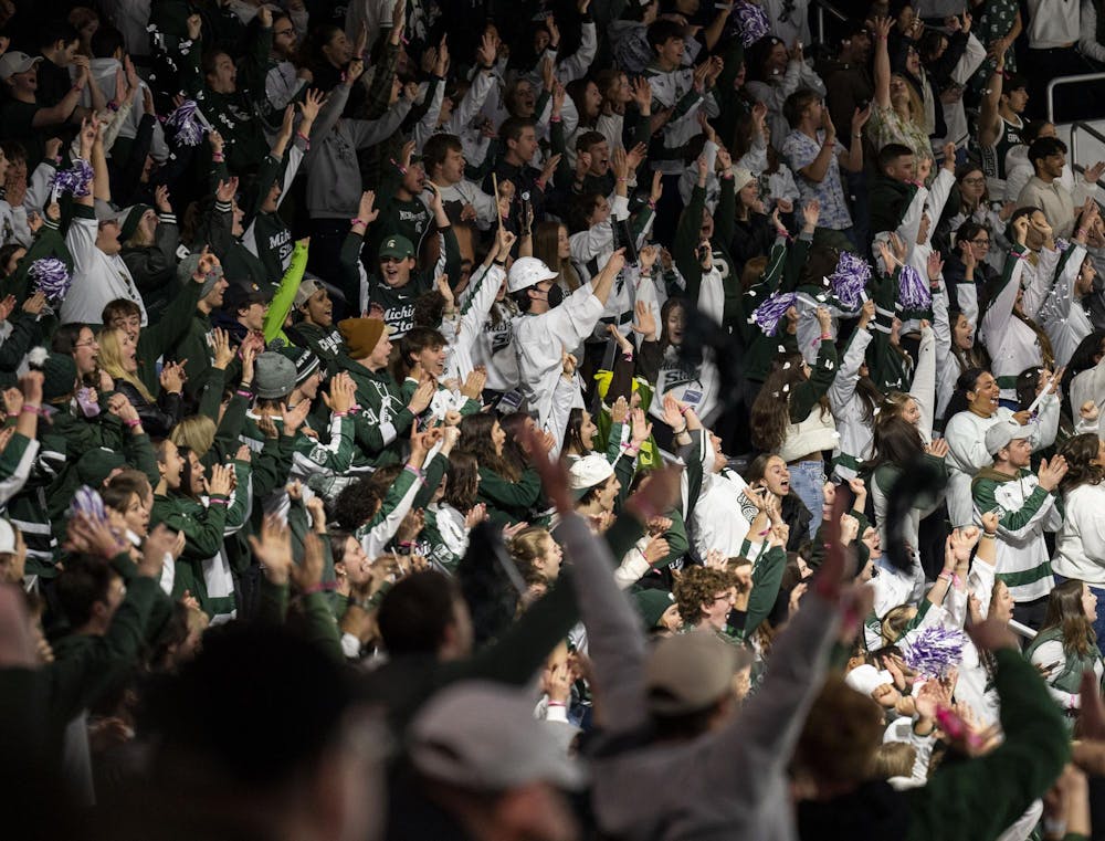 <p>Michigan State University fans cheer in the student section after MSU scored their first goal against Notre Dame at Munn Ice Arena on Nov. 16, 2024.</p>