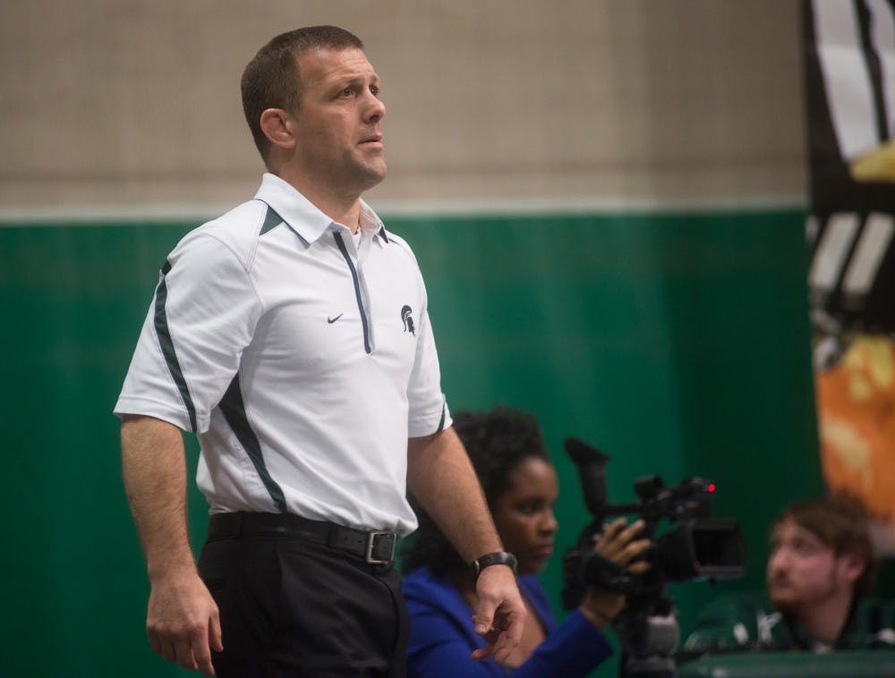 Head coach designate Roger Chandler watches a match during a meet against Eastern Michigan University on Dec. 2, 2015 at Jenison Field House. The Spartans were defeated by the Eagles, 34-0. 