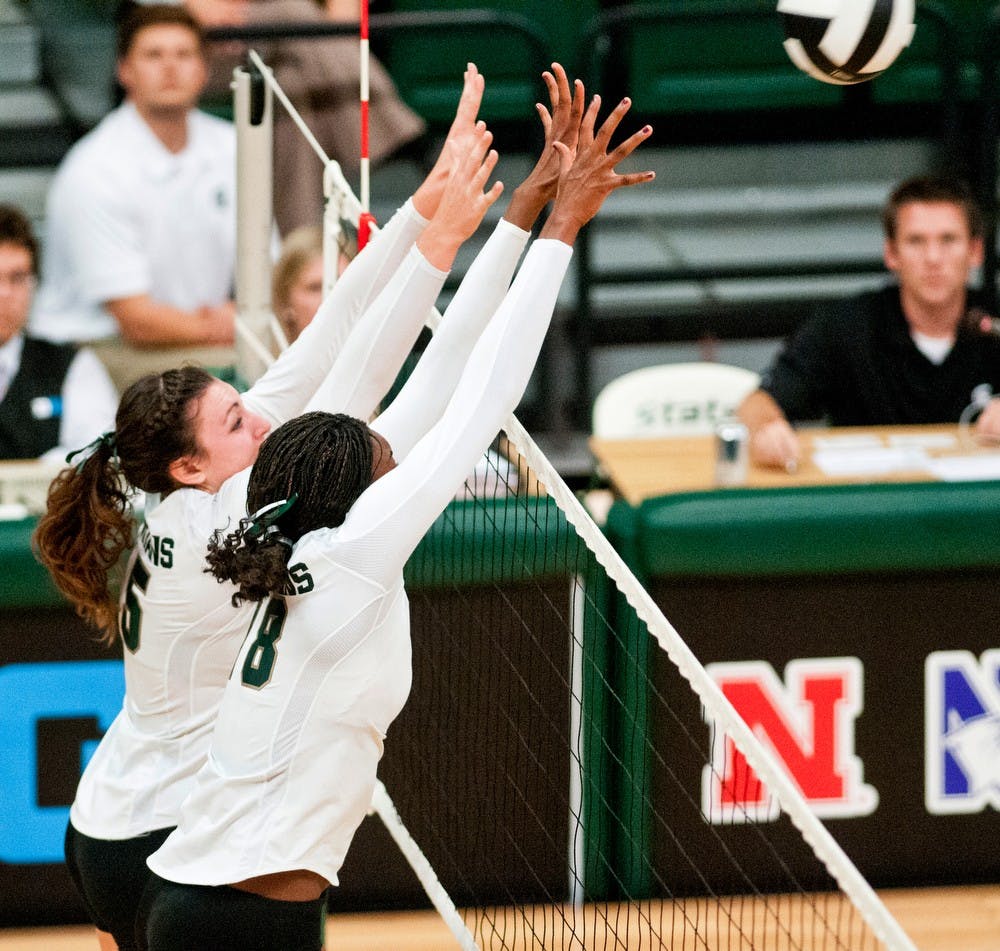 	<p>Senior outside hitter Lauren Wicinski, left, and senior middle blocker Alexis Mathews, right, go up for a block Sept. 20, 2013 at Jenison Field House. The Spartans defeated Eastern Michigan in three straight sets. Khoa Nguyen/ The State News</p>