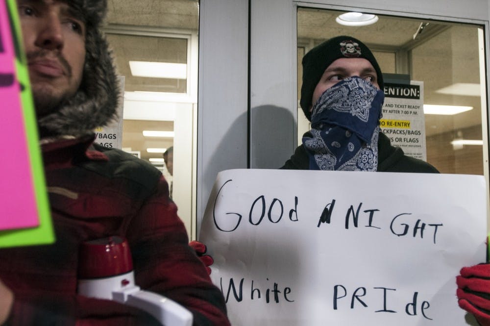 <p>&nbsp;People gather to protest the visit of speaker Milo Yiannopoulos on Dec. 7, 2016 outside Conrad Hall.<br>
 <strong>Photo by Derek VanHorn.</strong></p>