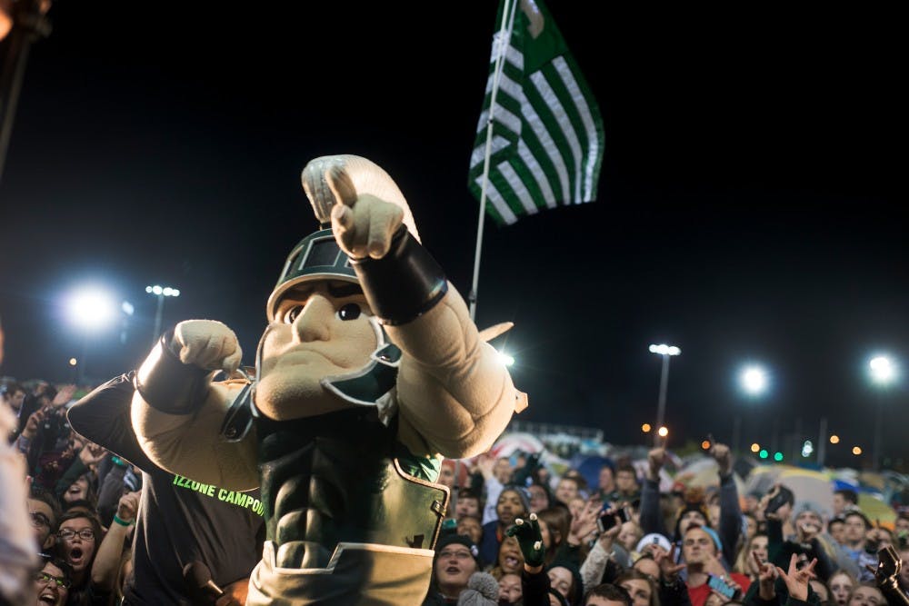 <p>Sparty poses for a picture with students behind him on Oct. 9, 2015, during the Izzone Campout at Munn Field. This annual event consists of students staying throughout the night in hopes of getting lower bowl seating. </p>