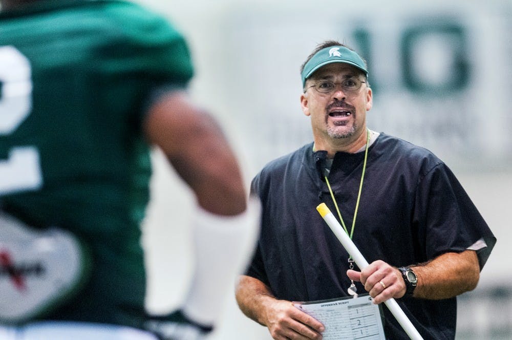 Defensive coordinator Pat Narduzzi instructs a player during practice, Monday, Aug. 13, 2012 at the Duffy Daugherty Football Building. The Spartan football team is gearing up for the 2012 season, opening Aug. 31 with a home game against Boise State. Adam Toolin/The State News
