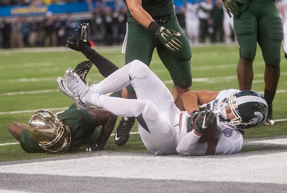 <p>Sophomore wide reciever R.J. Shelton scores a touchdown Jan. 1, 2015, during The Cotton Bowl Classic football game against Baylor at AT&T Stadium in Arlington, Texas. At halftime, the Bears were leading the Spartans, 24-14. Erin Hampton/The State News</p>