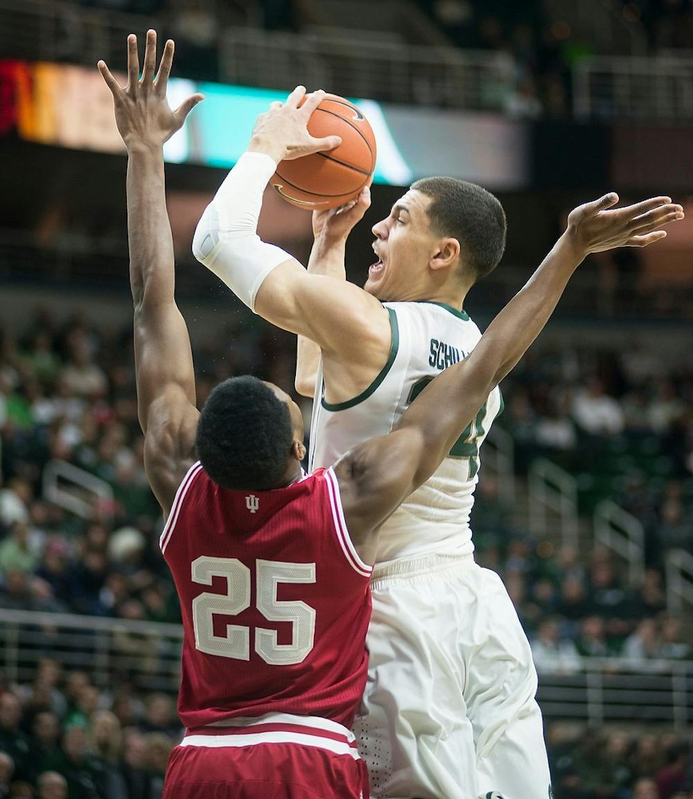 <p>Sophomore forward Gavin Schilling attempts a point over Indiana forward Emmitt Holt Jan. 5, 2015, during the game against Indiana at Breslin Center. The Spartans defeated the Hoosiers, 70-50. Erin Hampton/The State News</p>