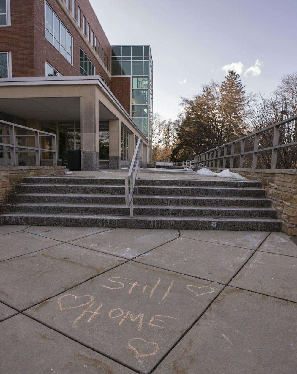 <p>A chalk message outside of the library reads “Still Home” on Sunday, Feb. 19, 2023, for Spartan Sunday - an event organized by alumni and Spartan parents to welcome students and faculty back to campus.</p>