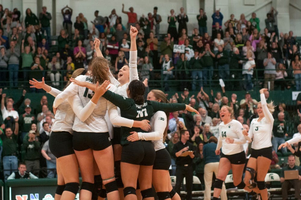 <p>Senior setter Halle Peterson celebrates the victory with her team at the volleyball game against the Michigan on Sept. 30, 2015 at Jenison Field House. The Spartans defeated the Wolverines, 3-0. </p>