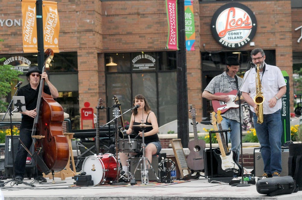 <p>Jeff Reynolds (bass), Jo Serrapere (drums) John Devine (Guitar) and Will Metz (saxophone) plays for the audience near Leo's Coney Island on June 29, 2015. This performance was part of the  Summer concert Series that is running August 1st. Joshua Abraham/The State News</p>