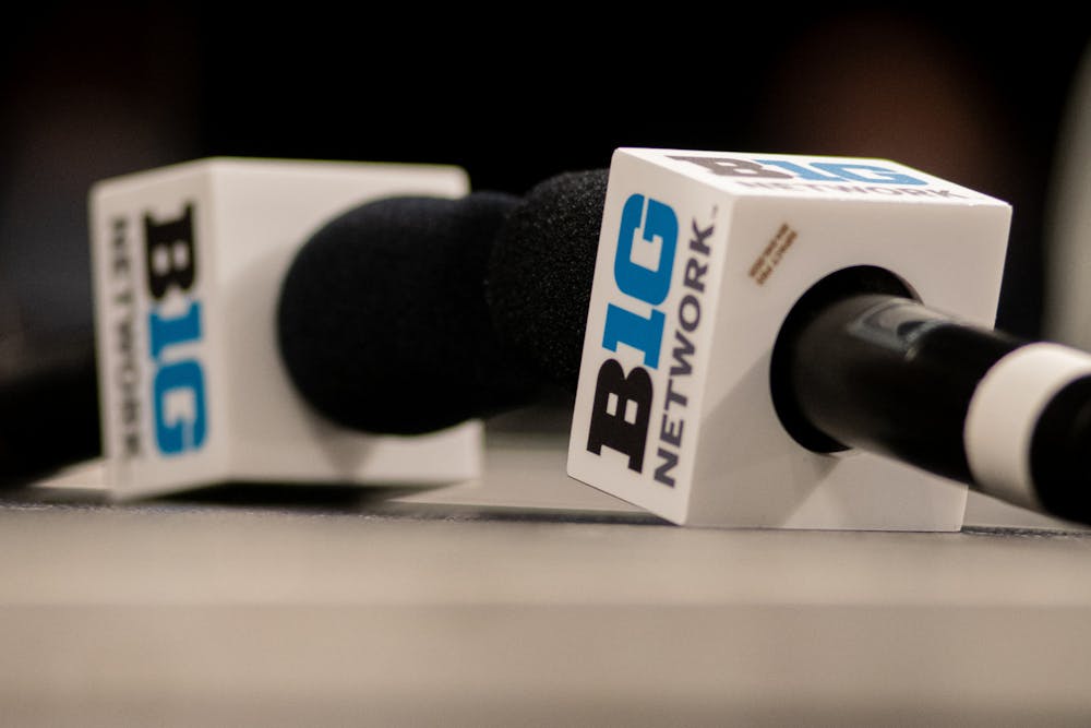 <p>Mics sit on a table, prior to the start of Big Ten media day at Gainbridge Fieldhouse in Indianapolis, Ind. on Oct. 8, 2021.</p>