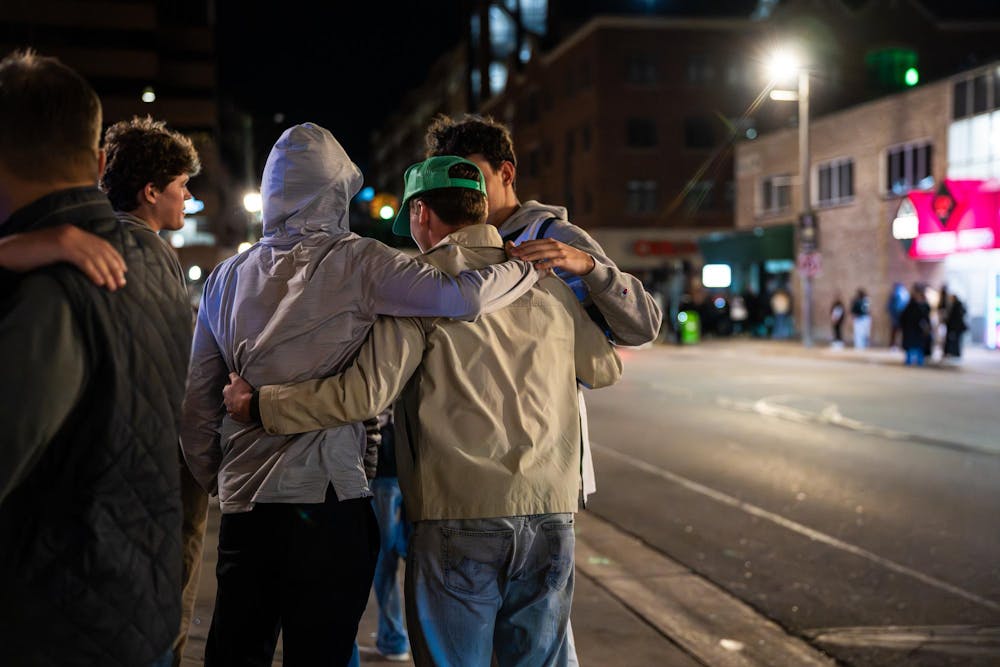 <p>Fans embrace on Grand River Ave. in East Lansing, Michigan, after watching UConn defeat Michigan State in the NCAA men’s basketball tournament regional semifinal game on Friday, March 27, 2026.</p>