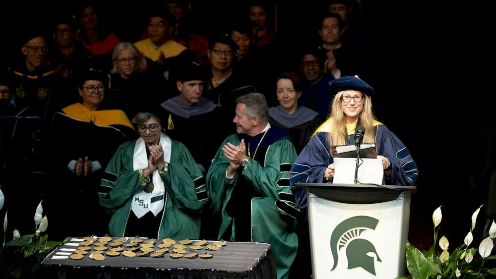 MSU Provost and Executive Vice President for Academic Affairs Laura Lee McIntyre speaks from the podium as MSU President Kevin M. Guskiewicz applauds during the 2026 State of the University Address at the Pasant Theatre in the Wharton Center for Performing Arts at MSU on Tuesday, Sep 29, 2026.