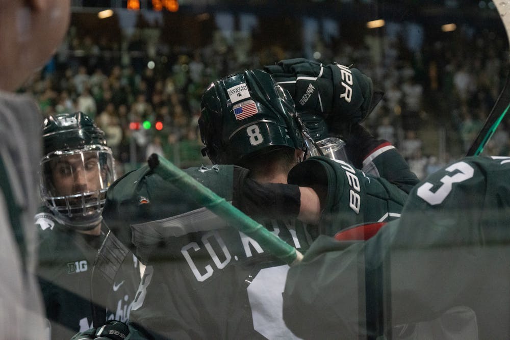 <p>MSU defenseman Cole Krygier embraces a teammate after a Spartan goal at Compton Family Ice Arena in Notre Dame, IN on Friday, March 4, 2023. MSU’s offense clicked during the third period as they took a 4-1 lead over Notre Dame early in the period.</p>