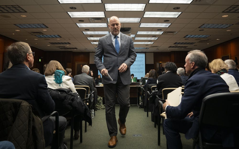 <p>Trustee candidate and swim and dive dad Mike Balow leaves the podium during the Board of Trustees meeting on Friday, Dec. 16, 2022 at the Hannah Administration Building. </p>