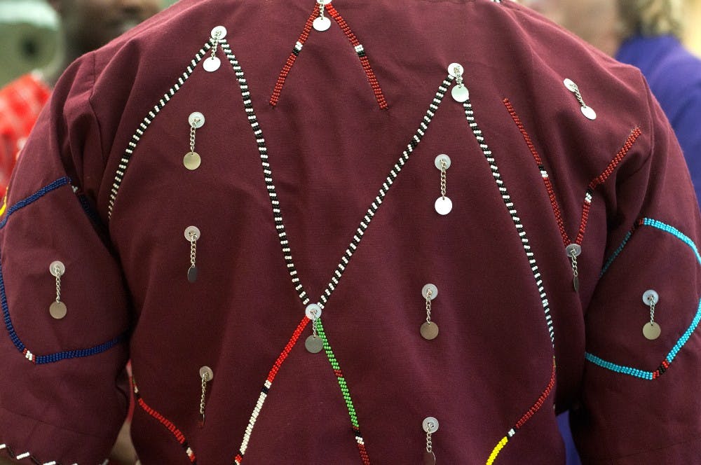 Agribusiness management sophomore Dominic Nangea, who is an international student from Kenya, wears traditional Maasai clothing during the East Lansing Welcomes the World event at the East Lansing Public Library, 950 Abbot Road. Nangea wore traditional clothing and carried a Maasai peace staff to the event to show his culture. Julia Nagy/The State News