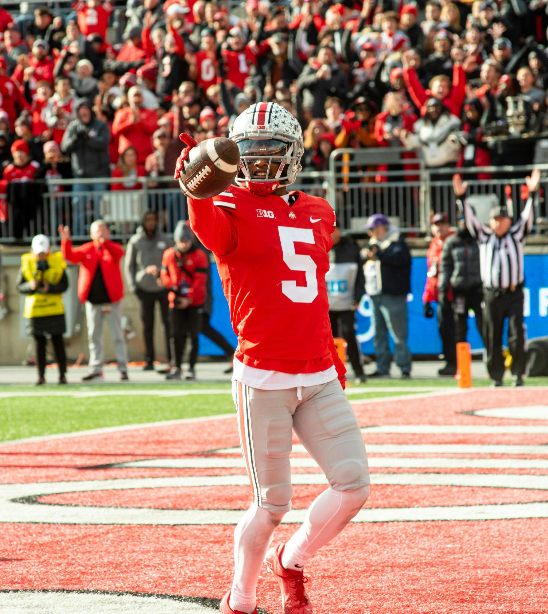 <p>Ohio State wide receiver Garrett Wilson (5) shows off the ball after scoring a touchdown during Michigan State&#x27;s loss to Ohio State on Nov. 20, 2021.</p>