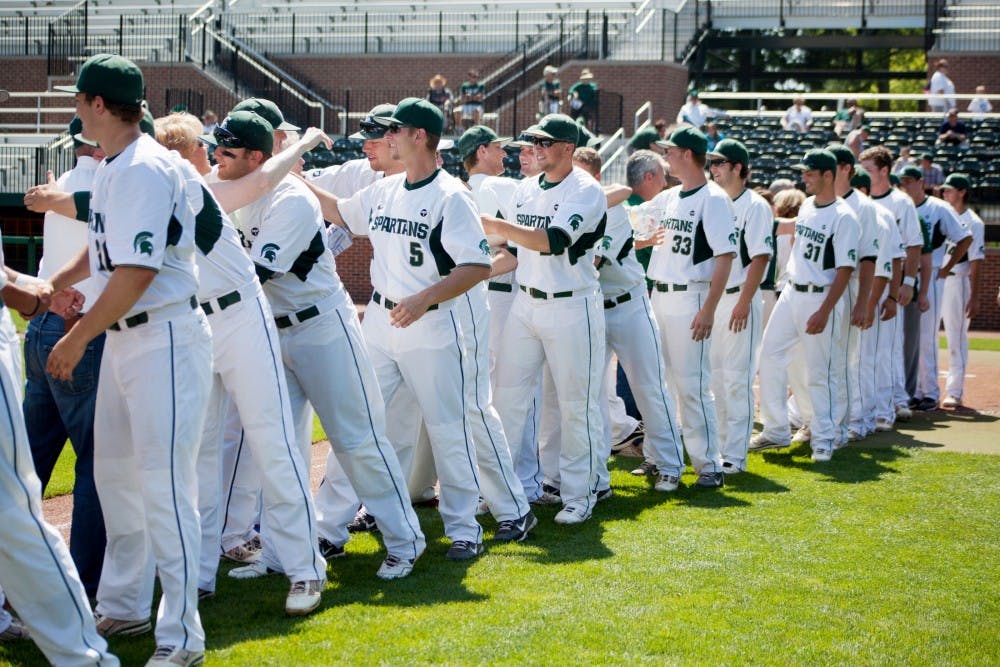 Underclassmen players gather on the field to embrace senior players and their families during the game against Penn State on May 19, 2012 at McLane Baseball Stadium at Old College Field. The Spartans beat Penn State 9-2. Julia Nagy/The State News