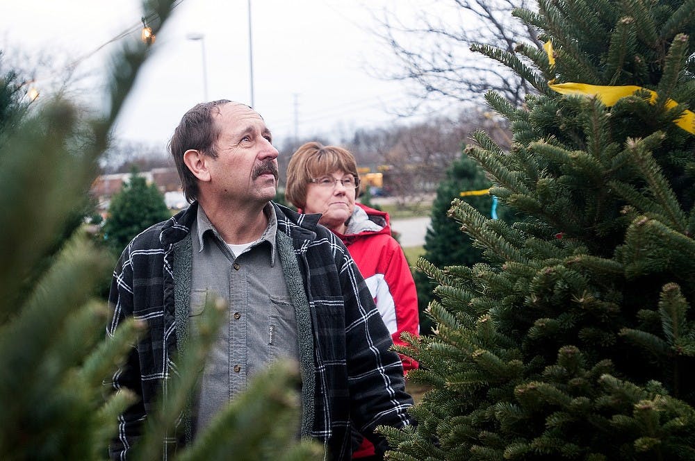 	<p>From left, Jackson residents Les Shearer and Mary Shearer look for the perfect Christmas tree Monday, Nov. 26, 2012, at Watson Tree Farms&#8217; lot located in the Meijer parking lot, 2055 W. Grand River Ave. Watson Tree Farms works with <span class="caps">MSU</span> all year-round helping with tree care. Adam Toolin/The State News</p>