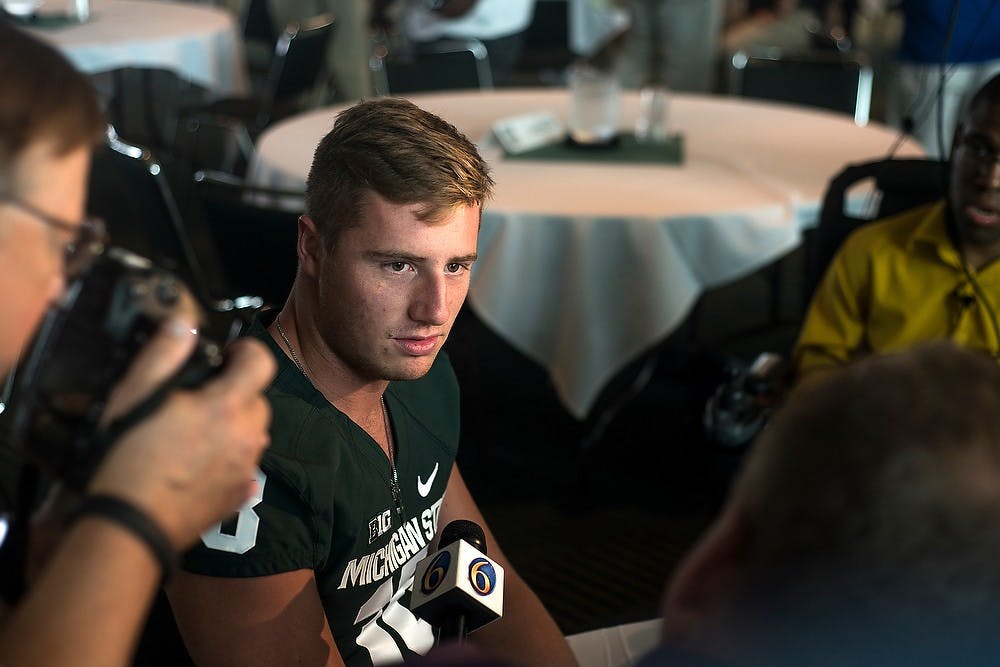 <p>Junior quarterback Connor Cook talks to the media during Football Media Day at the Huntington Club of Spartan Stadium. Coming off of a 13-1 season and a Rose Bowl victory, the Spartans are due to kick off the season Aug. 29. Danyelle Morrow/The State News</p>