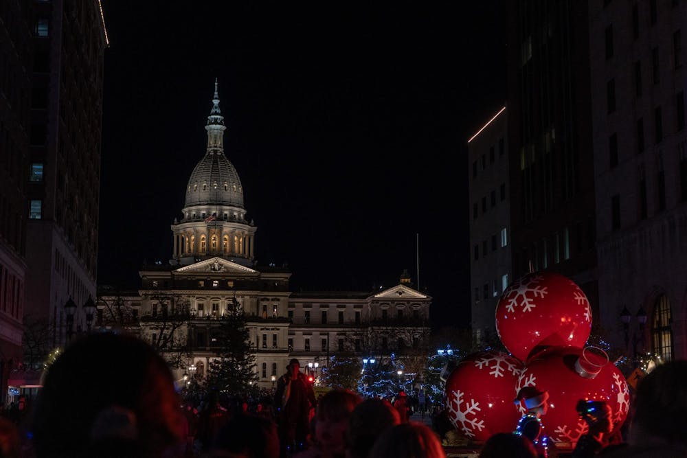 Holiday decor and attire filled the streets of downtown Lansing before the tree lighting at the Michigan State Capitol on Nov. 17, 2023. 