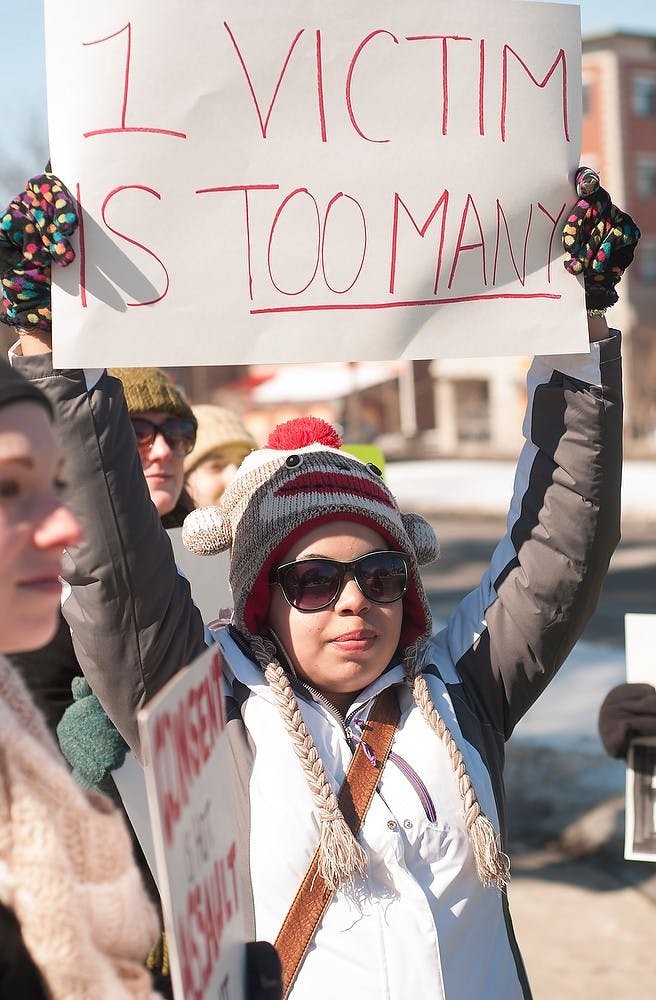 <p>English sophomore Kelsey Wiley holds up a sign Feb. 28, 2015, during the V-Day March from the Union, 49 Abbot Rd., to the Wharton Center on 750 East Shaw Lane. Individuals taking part in the march held signs protesting sexual violence and rape culture. Alice Kole/The State News</p>